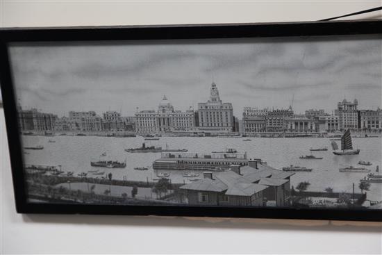 A Chinese machine embroidered silk picture of the river front of Shanghai, 1930s, 18.5 x 84cm., framed and glazed